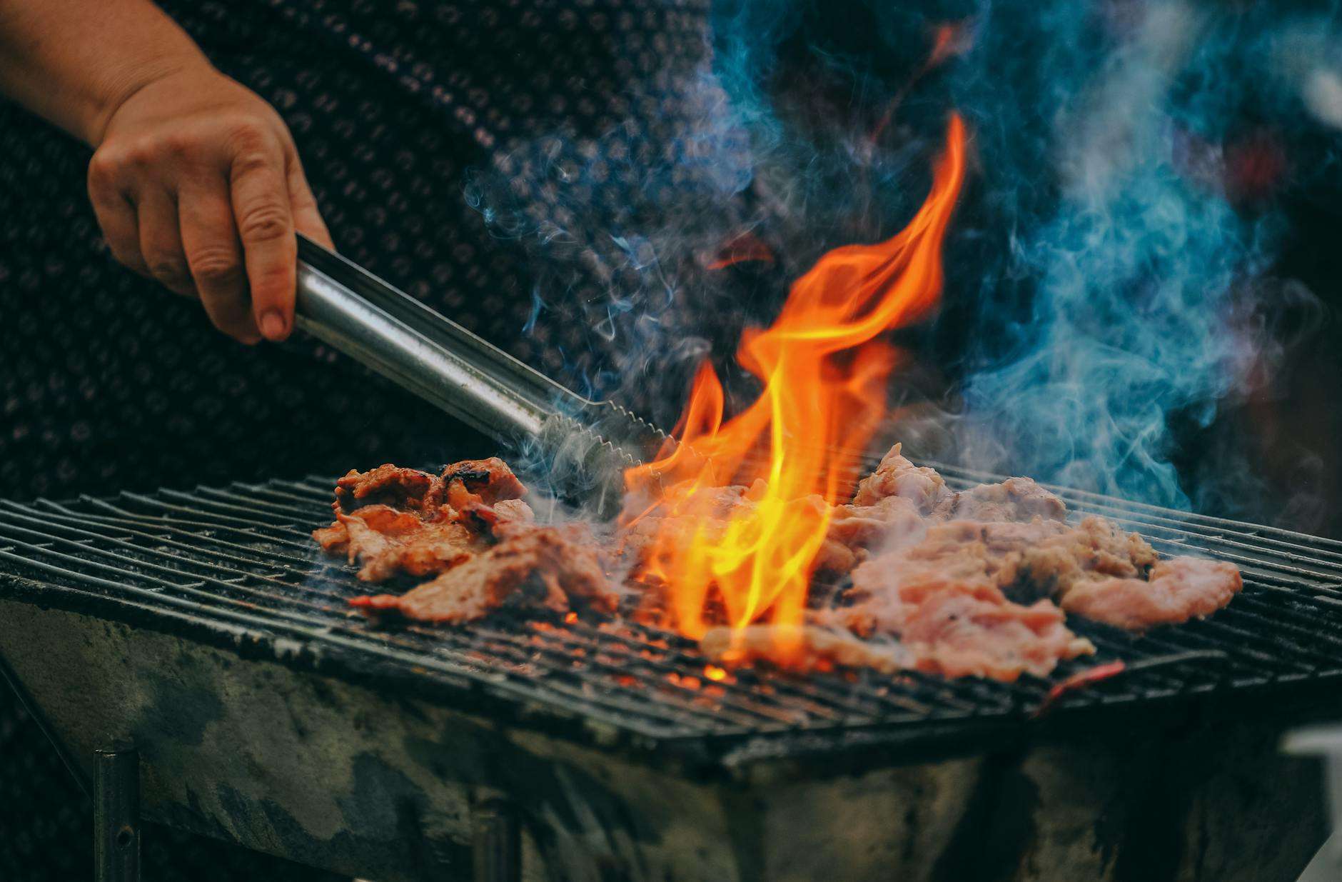 https://www.pexels.com/photo/close-up-photo-of-man-cooking-meat-1482803/