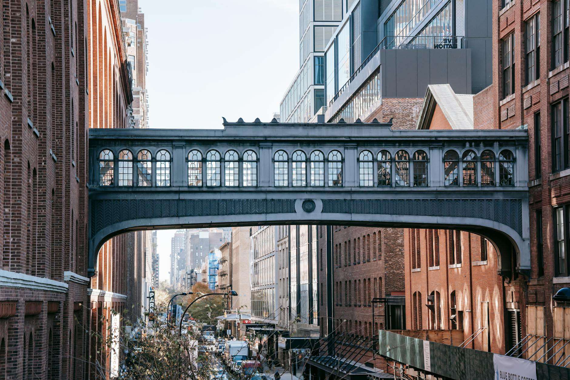 https://www.pexels.com/photo/modern-bridge-between-brick-buildings-on-street-6084424/
