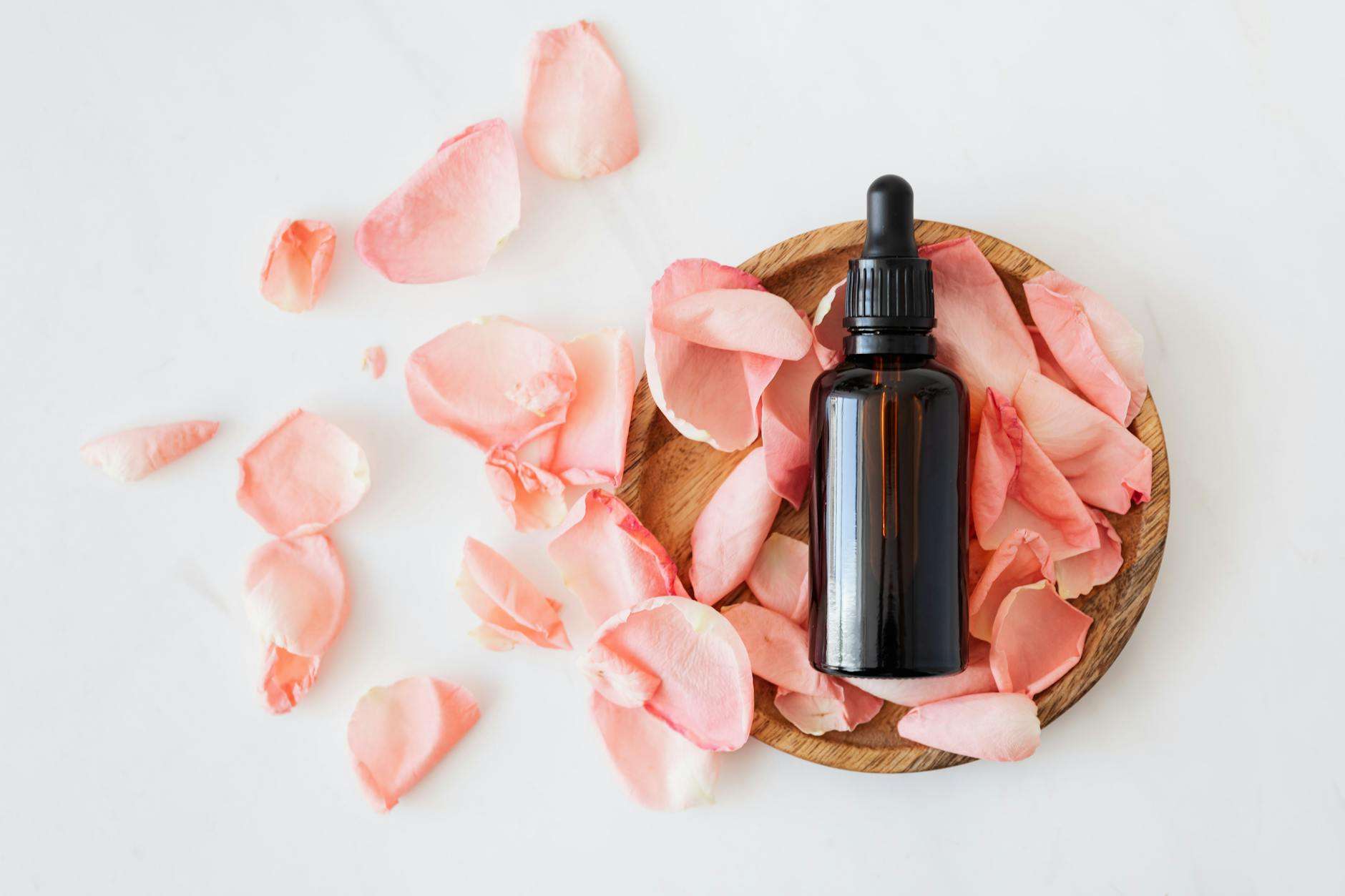 https://www.pexels.com/photo/composition-of-cosmetic-bottle-with-pink-rose-petals-and-wooden-plate-4041392/