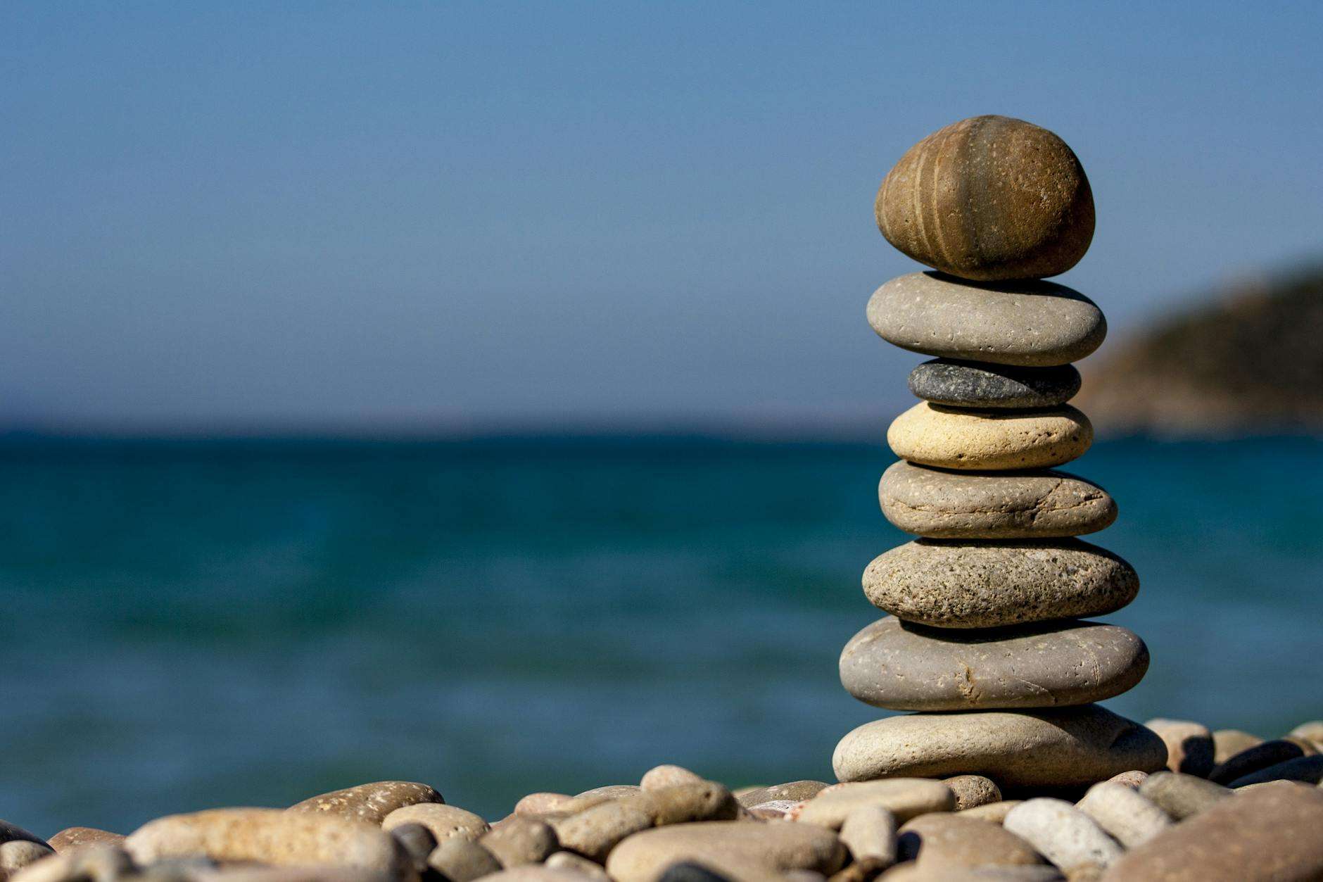 https://www.pexels.com/photo/cairn-stones-and-body-of-water-in-distance-235990/