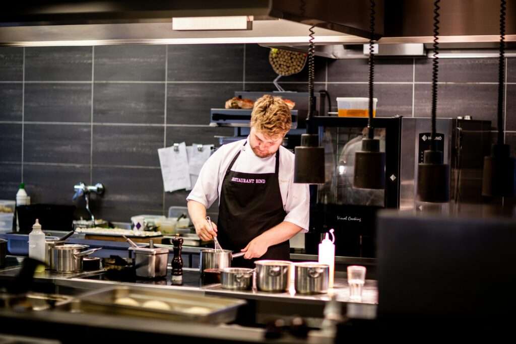  a man cooking in a kitchen